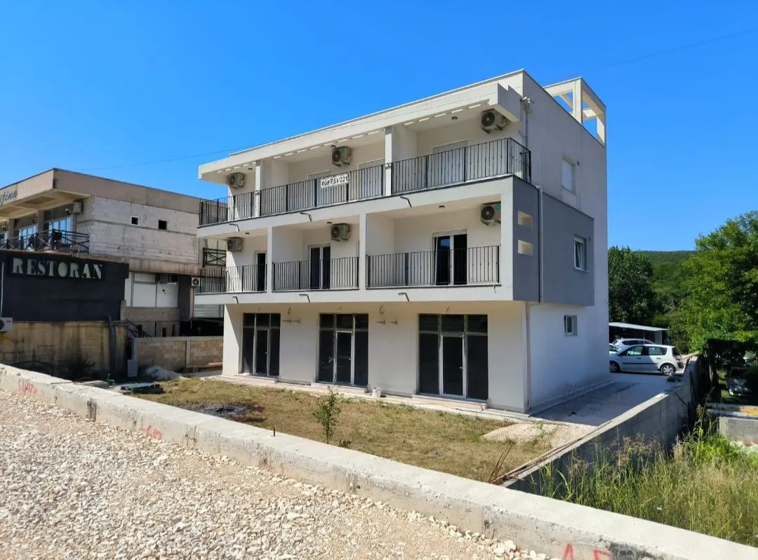 Exterior view of a multi-story residential building with terraces.