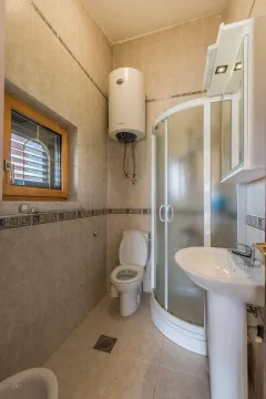 Bright bathroom with a shower cabin and water heater. - image 18