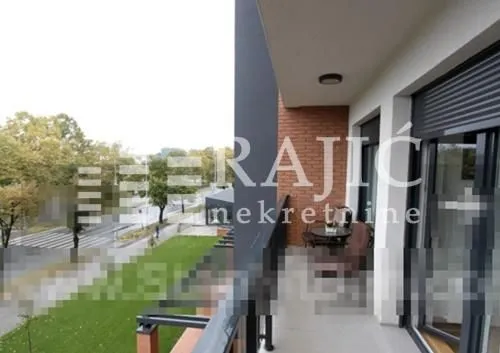 Spacious balcony with seating furniture and a view of the surroundings.