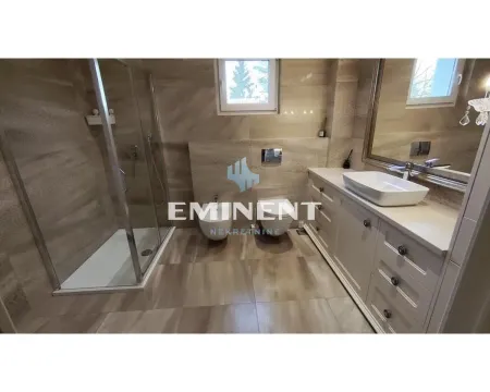 Modern bathroom with a shower cabin, washbasin, and sanitary fixtures. - image 14