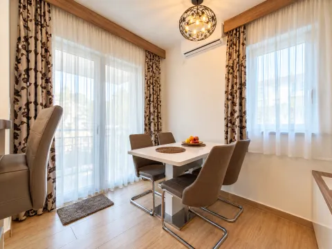 Dining area with a table, chairs, and access to the terrace. - image 9
