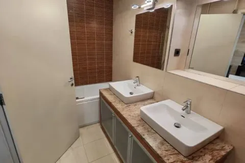 Bathroom with two washbasins, a countertop, and a bathtub. - image 7