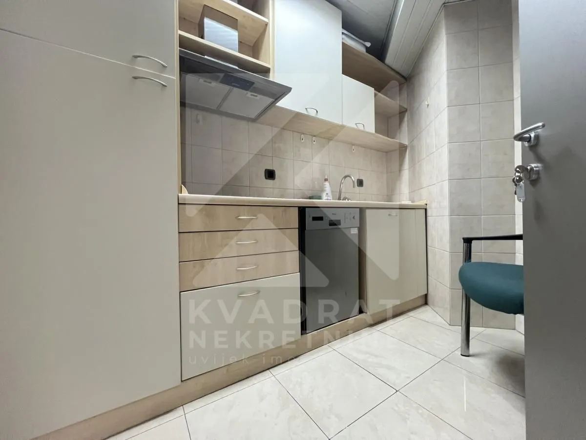 Small kitchen with light-colored cabinets and a sink.