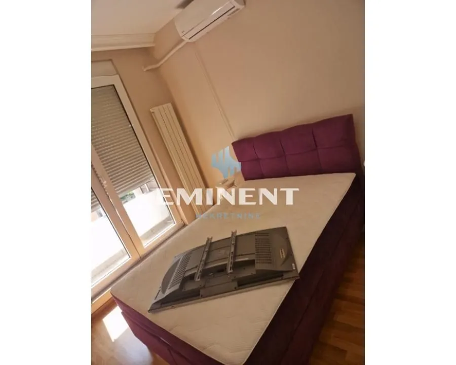 Furnished bedroom with a double bed and air conditioning.