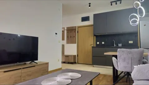 Modern living room with dining area and kitchen in the background. - image 4