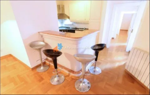 Kitchen with a counter and bar stools. - image 12