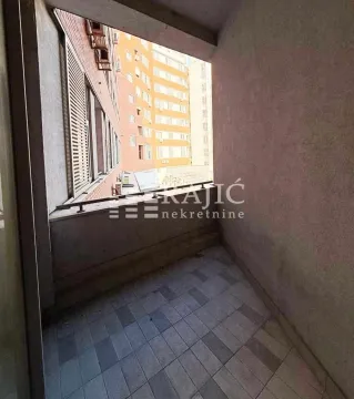 Small covered balcony with tiled flooring and a view of neighboring buildings. - image 7