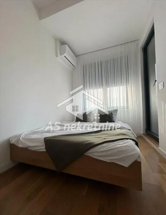 Bedroom with a double bed and air conditioning.