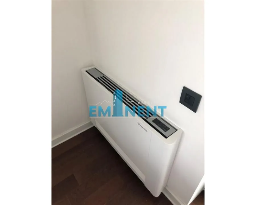 Close-up view of a wall-mounted air conditioning unit in a room.