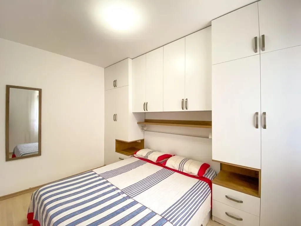 Bedroom with a double bed and fitted wardrobes.