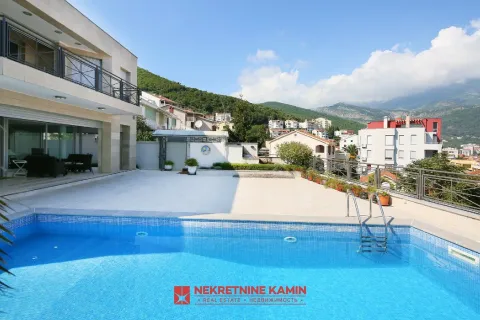 View of the swimming pool and spacious terrace in front of the building with surrounding landscape. - image 8