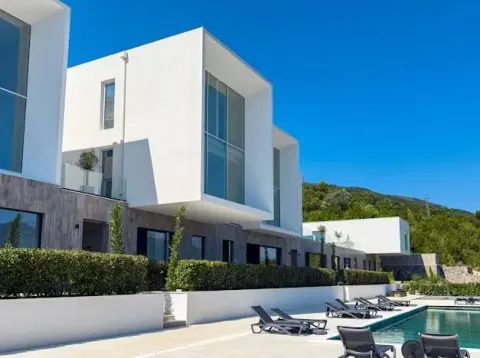 Exterior of a modern residential building with a swimming pool and sun loungers. - image 10