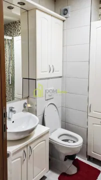 Smaller bathroom with a washbasin, toilet, cabinet, and shower enclosure. - image 5
