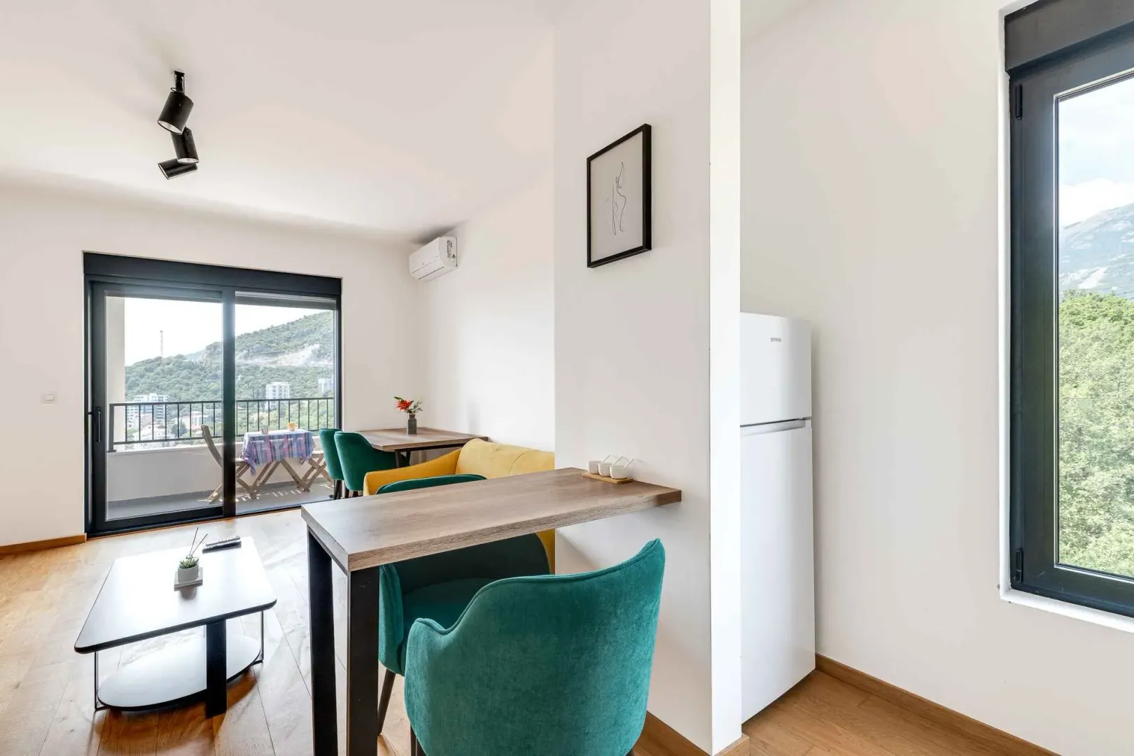 Bright living room with dining area and terrace access.
