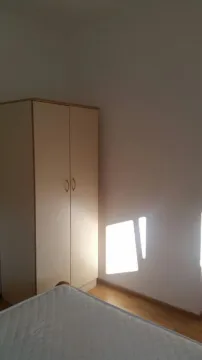A simply furnished bedroom featuring a two-door wardrobe. - image 14