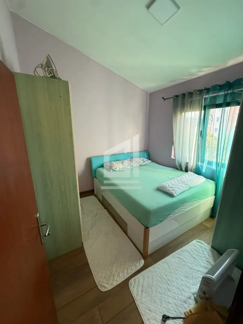 Small bedroom with a double bed, wardrobe, and window.
