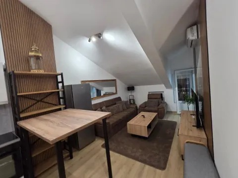Living room with sofa set, dining table and kitchen elements in the attic. - image 7