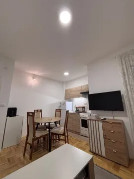 Living room with dining area and kitchen in the background. - image 2