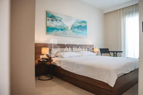 Spacious bedroom with a large double bed, wooden headboard, and an art painting on the wall. - image 14