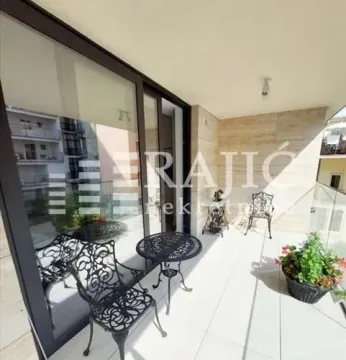 Spacious terrace with patio furniture and a view of the surroundings. - image 18