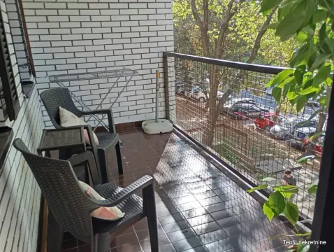Furnished balcony with seating furniture and a street view. - image 14