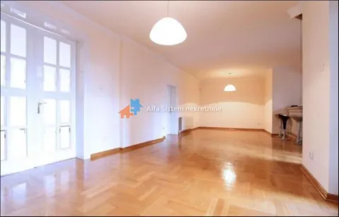 Spacious empty room with parquet flooring and white walls. - image 11