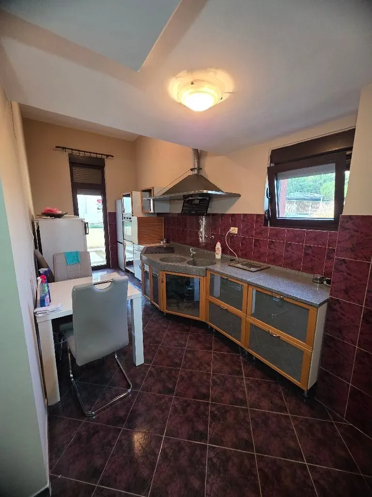 Kitchen equipped with cabinetry and a dining table with chairs.