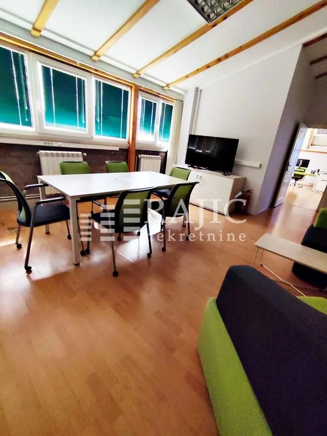 Spacious office with a work desk and chairs.