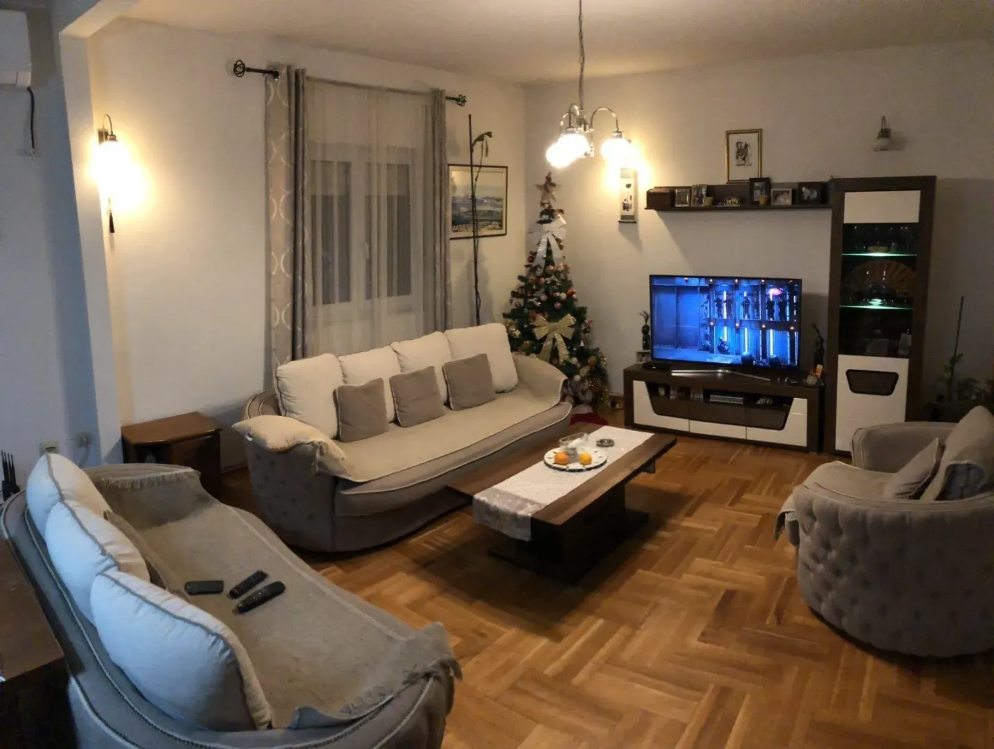 Living room with a seating set, coffee table, and television.