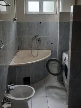 Bathroom with tiles, corner bathtub, bidet and washing machine. - image 4