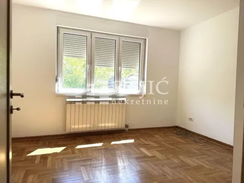 Empty room with parquet flooring and a window. - image 4