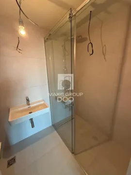 Newly equipped bathroom with a washbasin and glass shower cabin. - image 11