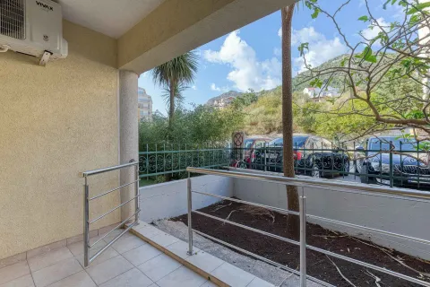 Covered terrace with a metal railing and a view of the courtyard and greenery. - image 27