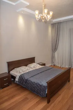 Furnished bedroom with a double bed, nightstands, and curtains. - image 12
