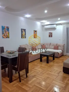 Living room with a sofa set, dining table, and parquet flooring. - image 2