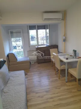 Living room with seating furniture and a dining table. - image 6