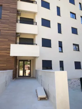 Main entrance and facade of a modern residential building. - image 10