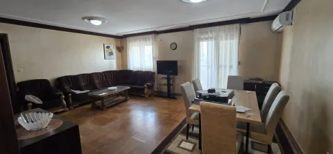 Spacious living room with a sofa set and a dining table. - image 3