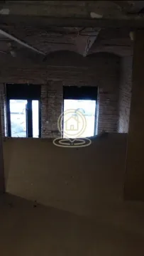Unfinished interior space under renovation with exposed brick and vaulted ceiling. - image 2