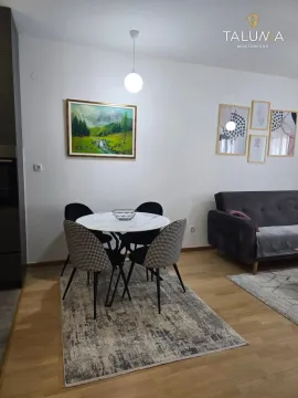 Living room with a dining table and chairs. - image 6