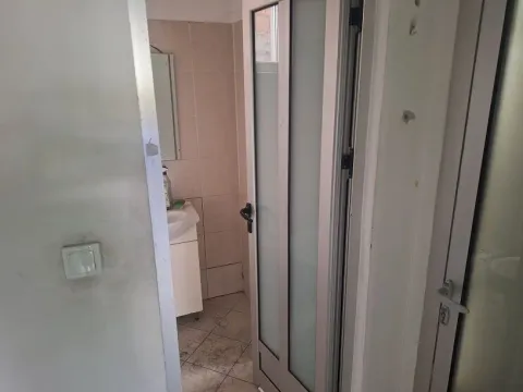 View of the bathroom from the hallway through the open door. - image 6