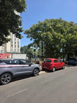 View of the exterior area with parked cars and trees. - image 4