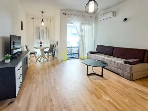 Living room with sofa, TV unit, and dining area with access to the terrace. - image 9