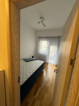 View from the hallway into a bedroom with a bed and access to the terrace. - image 8
