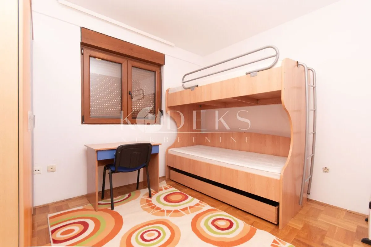 Children's room with a bunk bed and a desk.