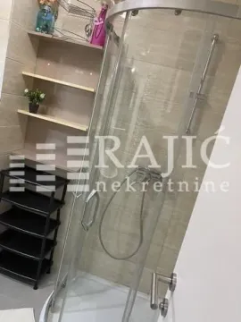 Bathroom with a shower cabin and shelving. - image 16