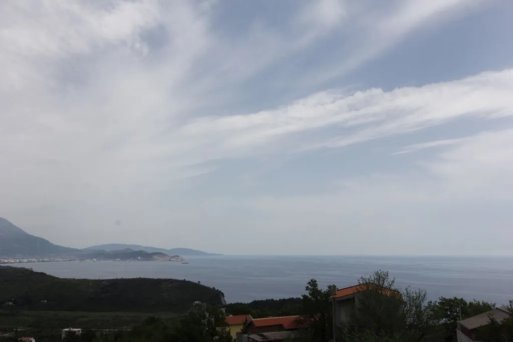 Panoramic view of the sea and hills in the distance.