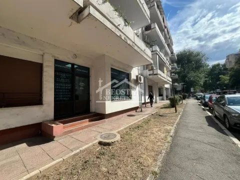Exterior view of the commercial space with an entrance and sidewalk on the street. - image 2
