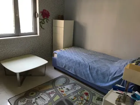 Small bedroom with a single bed, chest of drawers, and a window. - image 5