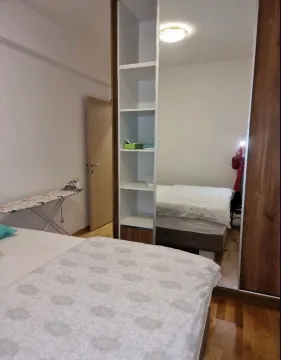 Furnished bedroom with a large wardrobe and bed. - image 12